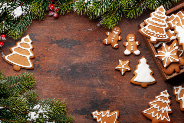Christmas card with gingerbread cookies and fir tree. Top view flat lay with space for xmas greetings - 写真・画像