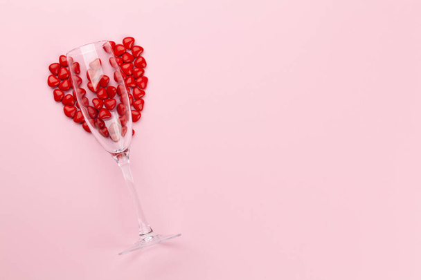 Valentines day card with champagne glass and heart shaped sweets. Top view flat lay with copy space - Photo, Image