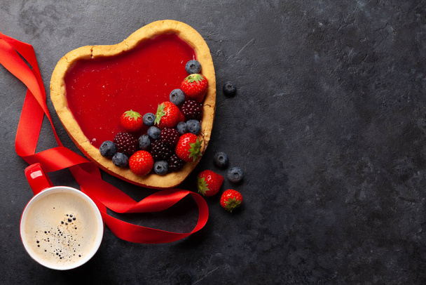 Heart shaped sweet cake with berries and coffee. Valentines Day greeting card. Top view flat lay with copy space - Photo, Image