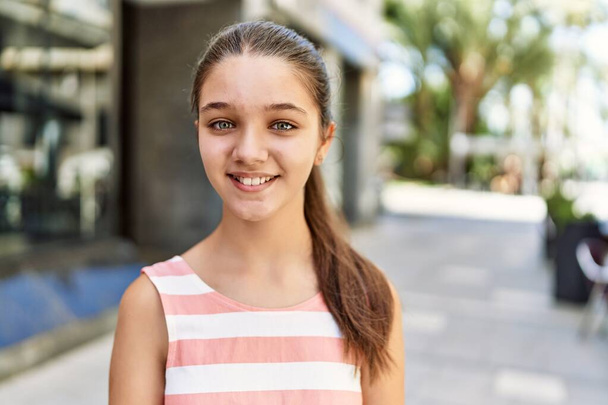 Caucasiano adolescente menina sorrindo feliz de pé na cidade. - Foto, Imagem
