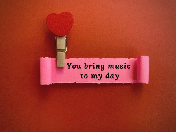 You bring music to my day label on torn paper with red paper background. Valentines Day concept - Foto, Bild