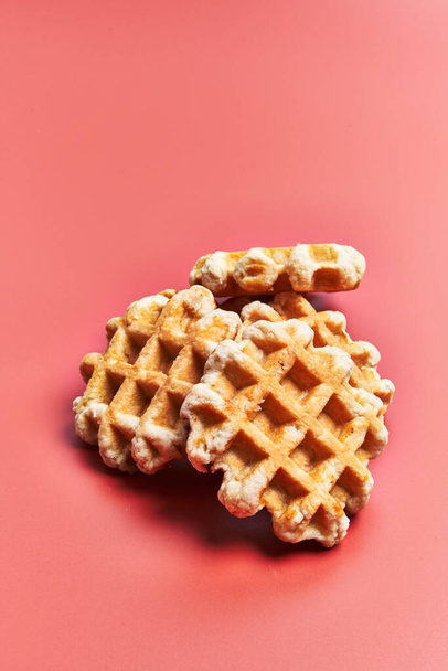  Bunch of delicious waffles over red background - Φωτογραφία, εικόνα
