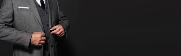 cropped view of businessman in blazer on dark grey background, banner - 写真・画像
