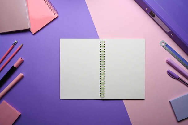 Empty notebook and stationery on purple background. - Valokuva, kuva