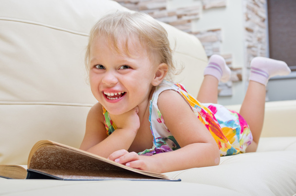 Little smiling girl with book - Фото, изображение