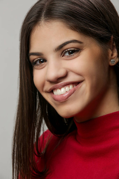 Studio portrait of attractive young woman in red  - Foto, imagen