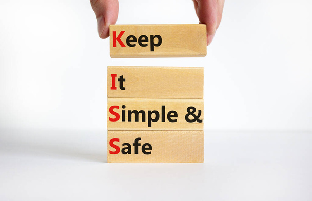 KISS keep it simple and safe symbol. Concept words KISS keep it simple and safe wooden blocks. Beautiful white table, white background. Business and KISS keep it simple and safe concept. Copy space. - 写真・画像