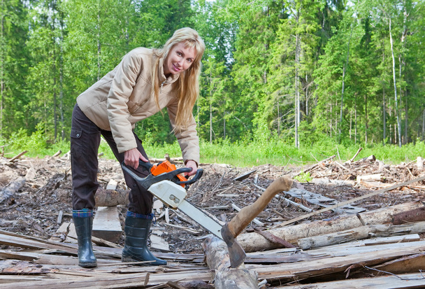 The young woman in wood saws a tree a chain saw - Photo, Image