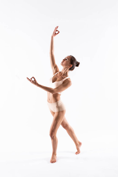 Athletic beautiful woman posing in sports underwear isolated on white background. - Valokuva, kuva
