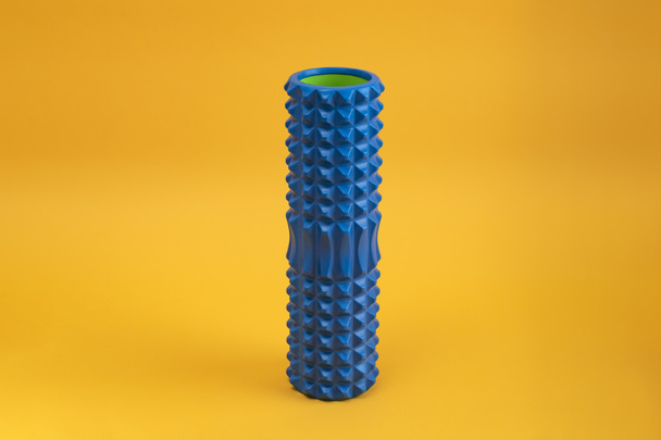 Tools for self-massage on yellow background. Foam roller for myofascial release. Massage roller - Photo, Image