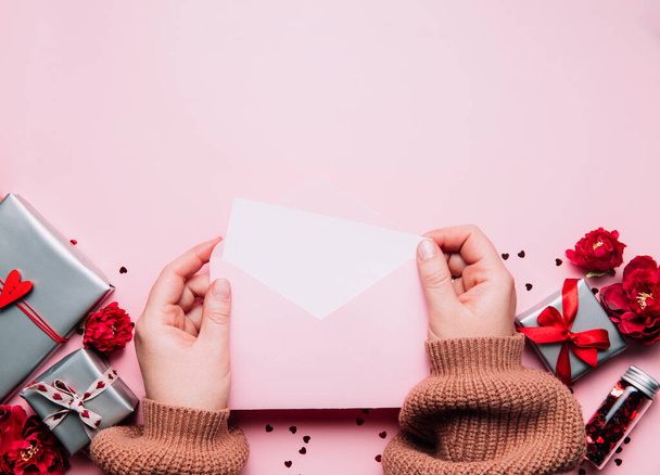 Female hands hold love letter message in envelope, Valentines Day greeting card - Fotoğraf, Görsel