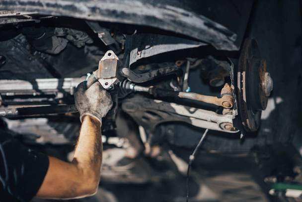 car suspension diagnostics, auto mechanic touches suspension arms and silent blocks - Fotografie, Obrázek