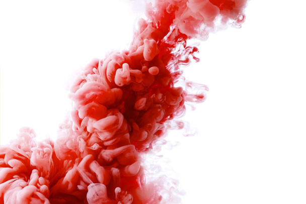 Diagonal splash of red paint in water against white background - Фото, изображение