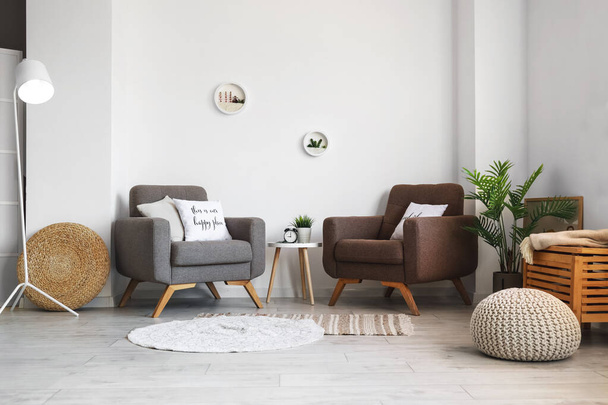Interior of modern living room with comfortable armchairs and table - Valokuva, kuva