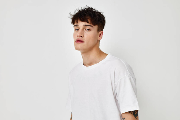 Photo young boyfriend modern youth style white t-shirt tattoo on the arm model studio - Foto, Bild