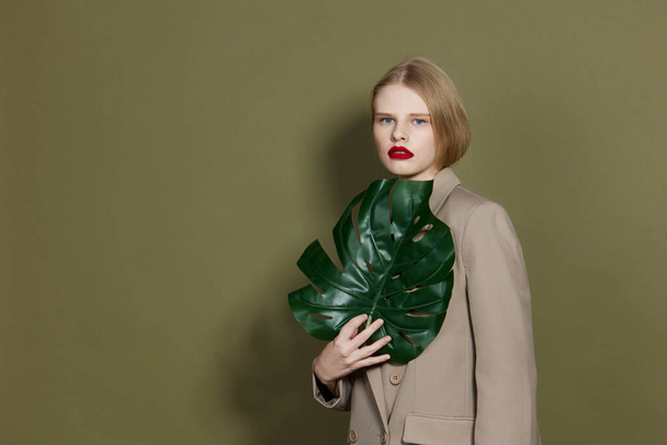 pretty woman red lips palm leaf charm fashion studio model unaltered - Foto, Imagen