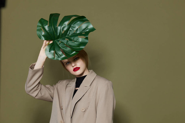 pretty woman red lips palm leaf charm fashion studio model unaltered - Foto, Imagem