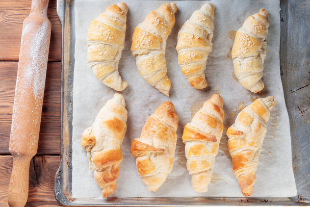 Top view of Homemade croissants on a baking paper. - Foto, Imagem