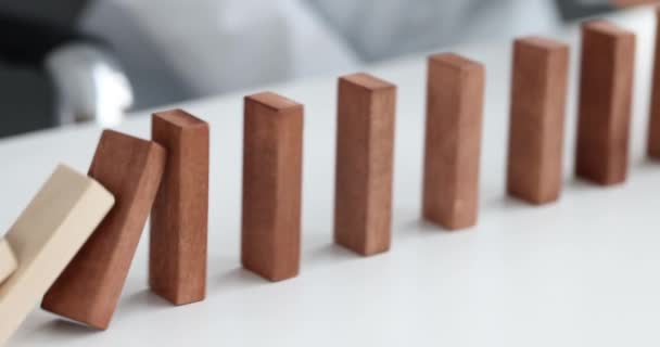 Risk and strategy in business is hand stopping the fall of wooden block - Video