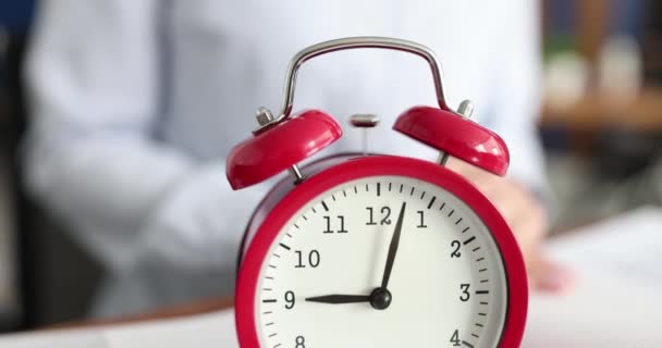 Red alarm clock rings at nine oclock closeup - 映像、動画