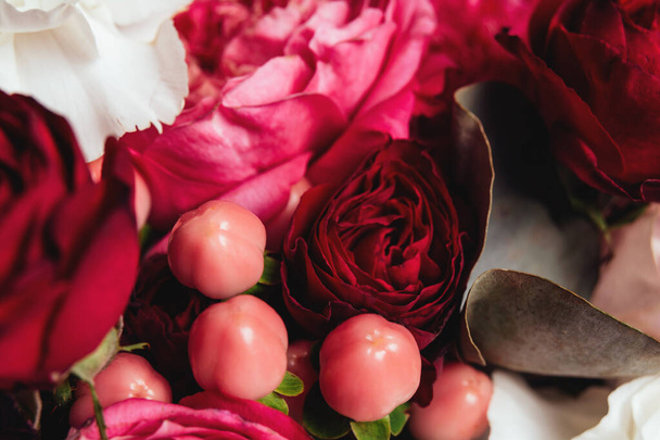 Beautiful bouquet of flowers, roses, carnations, eucalyptus, hypericum for a festive background. Natural texture - Fotoğraf, Görsel