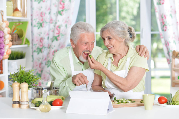 senior couple cooking together in kitchen - Φωτογραφία, εικόνα