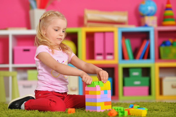 happy cute little girl playing with cubes - Zdjęcie, obraz