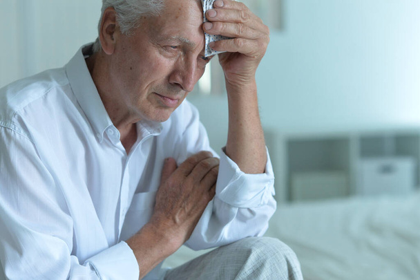 Portrait of sad sick senior man with headache  - Foto, Imagen