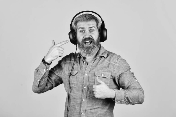 Dj hipster. Excellent music playlist. Hipster enjoy excellent sound song in earphones. Rhythm concept. Noise cancellation function. Music beat. Man bearded hipster headphones listening music - Photo, Image