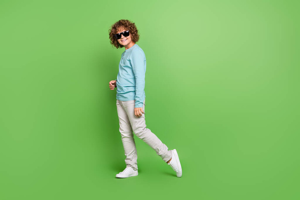 Full length body size view of attractive cheerful guy dancing posing rest isolated over vibrant green color background. - 写真・画像