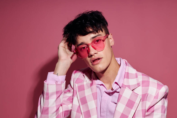 Photo of romantic young boyfriend in pink glasses pink blazer posing studio pink background unaltered - Foto, imagen