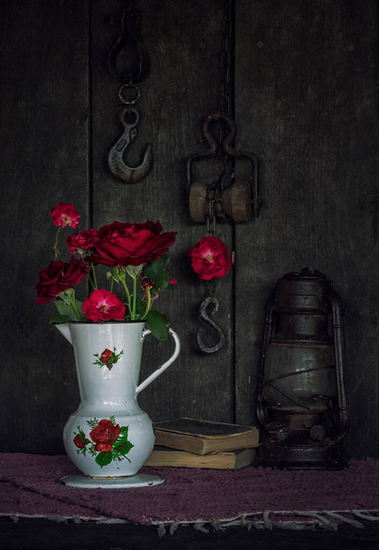 still life with a bouquet of red roses and old objects - Valokuva, kuva