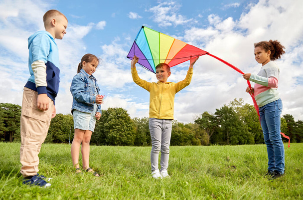 happy kids with kite playing at park - Fotó, kép