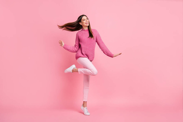 Photo of cute adorable young woman dressed knitted smiling dancing isolated pink color background. - 写真・画像