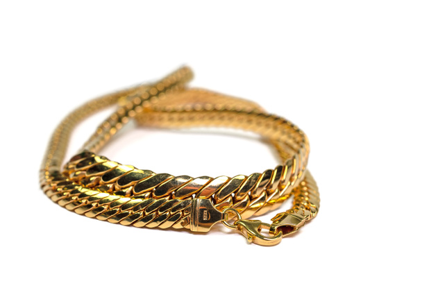 Gold chain, gold jewelry against a white background - 写真・画像