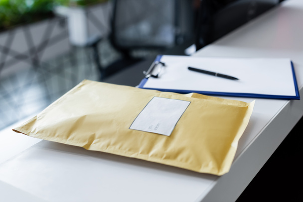 Parcel and blurred clipboard on reception in office  - Zdjęcie, obraz