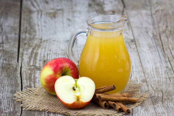 Apple juice and apples on wooden background - Photo, image