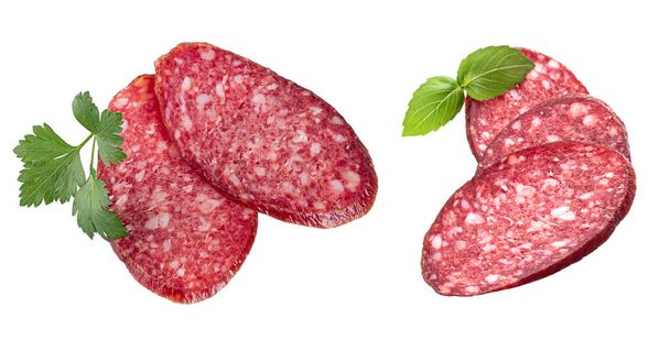 Slices of smoked sausage with fresh herbs, isolated on a white background - Photo, Image