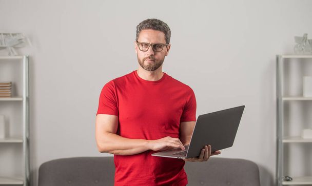 adult man in glasses typing text message in computer, cyber monday - Photo, Image