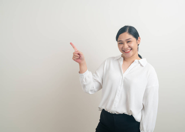 portrait Asian woman with hand pointing on white background - Photo, image