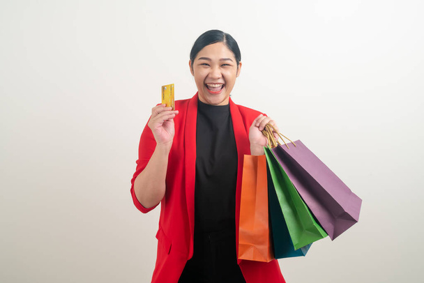 Asian woman holding shopping bag and credit card on hand with white background - Φωτογραφία, εικόνα