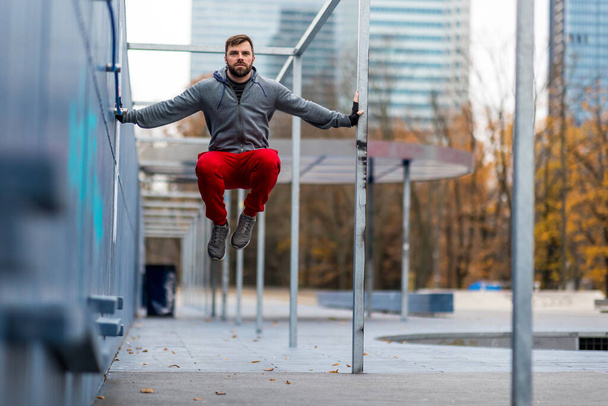 Young man exercising in urban setting - Photo, Image