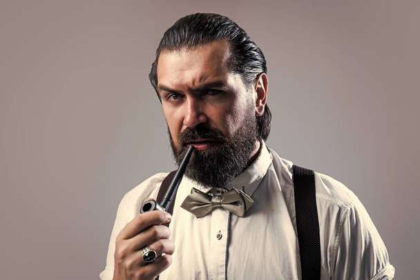 elegant brutal man in formal wear has groomed hair smoking pipe, addiction - Fotografie, Obrázek