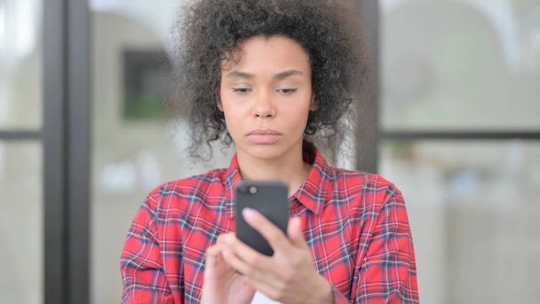 African Woman using Smartphone, Browsing Internet - Фото, изображение