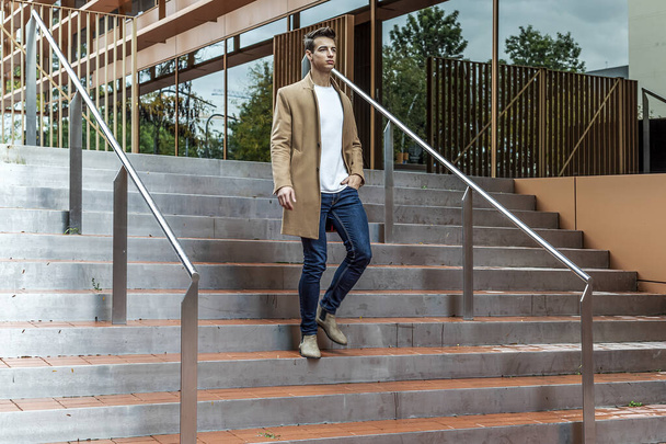 elegant and modern man walking down stairs with positive attitude - Φωτογραφία, εικόνα