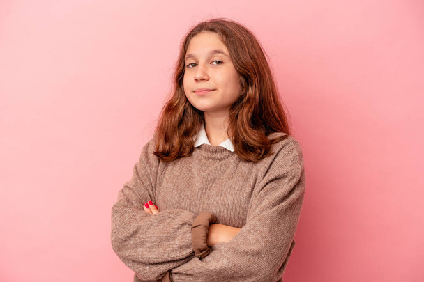 Little caucasian girl isolated on pink background suspicious, uncertain, examining you. - Photo, Image