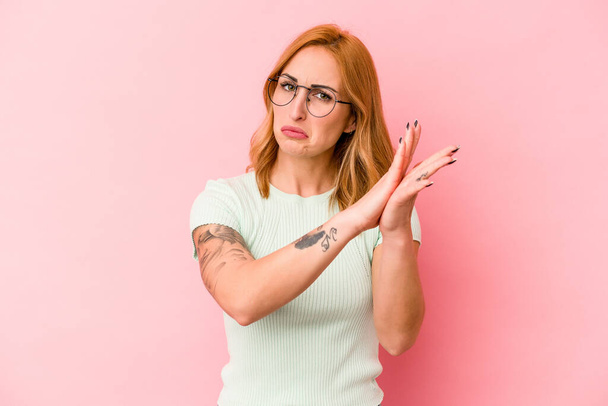Young caucasian woman isolated on pink background feeling energetic and comfortable, rubbing hands confident. - Photo, Image