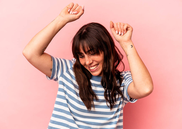 Young Argentinian woman isolated on pink background celebrating a special day, jumps and raise arms with energy. - Valokuva, kuva