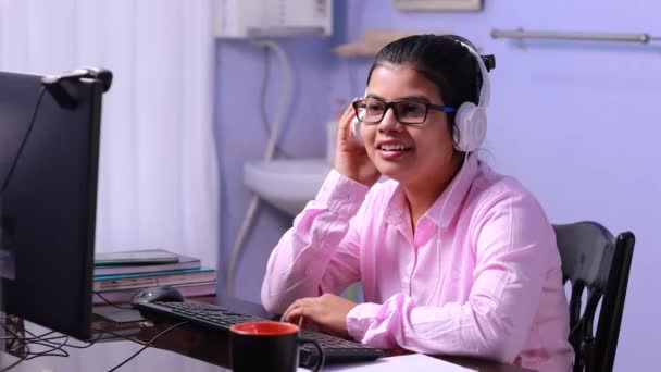 Indiase vrouw leraar in roze shirt video conferencing op computer thuis - Video