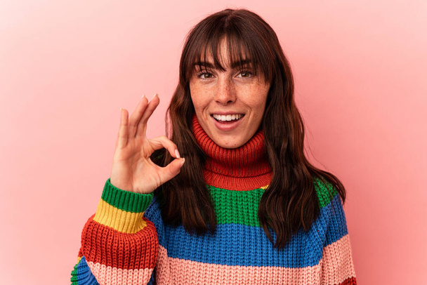 Young Argentinian woman isolated on pink background cheerful and confident showing ok gesture. - Photo, image